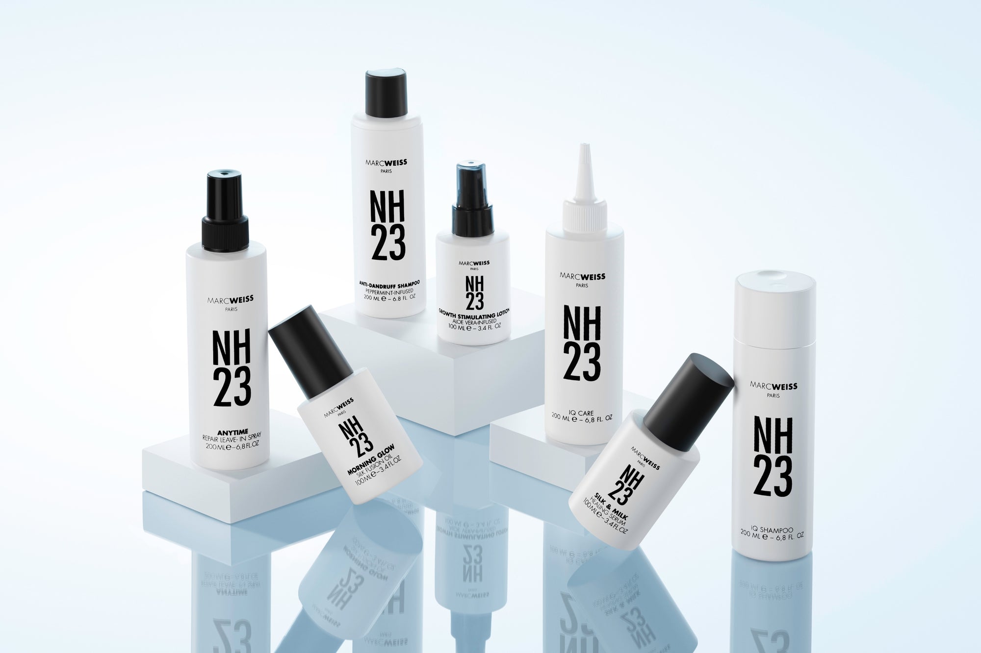 Blonde model holding NH23 shampoo and conditioner bottles